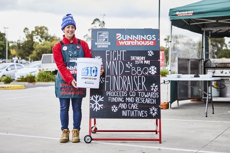 Team member collecting funds for charity at a Bunnings sausage sizzle