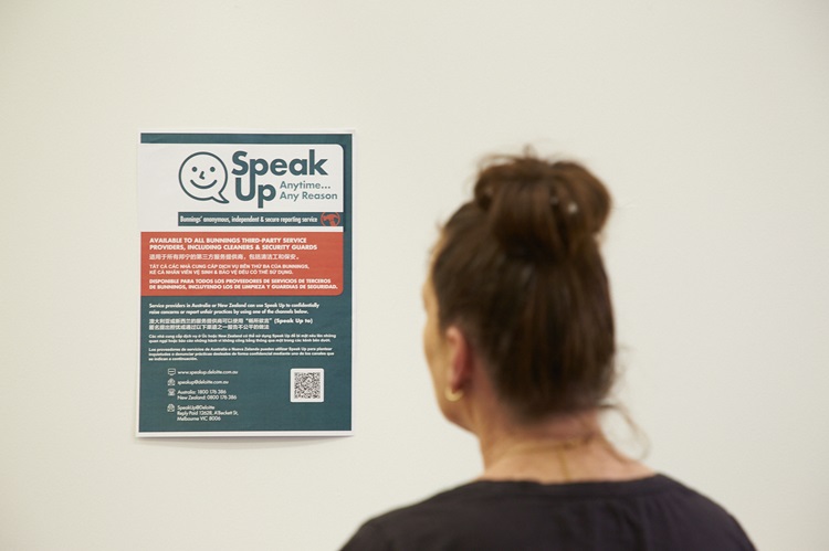 Team member looking at an ethical sourcing poster